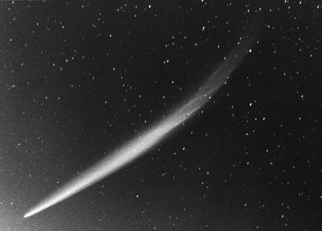 Sungrazer comet: White comet with long tail in a starry sky.