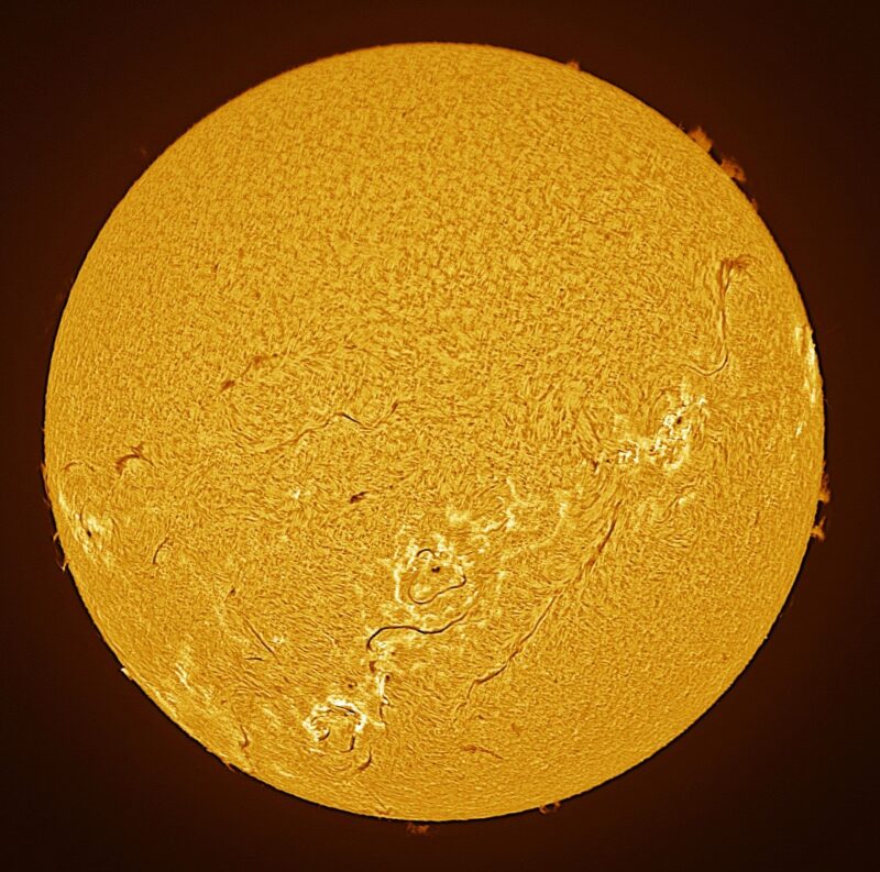 The sun, seen as a large yellow sphere with a mottled surface.