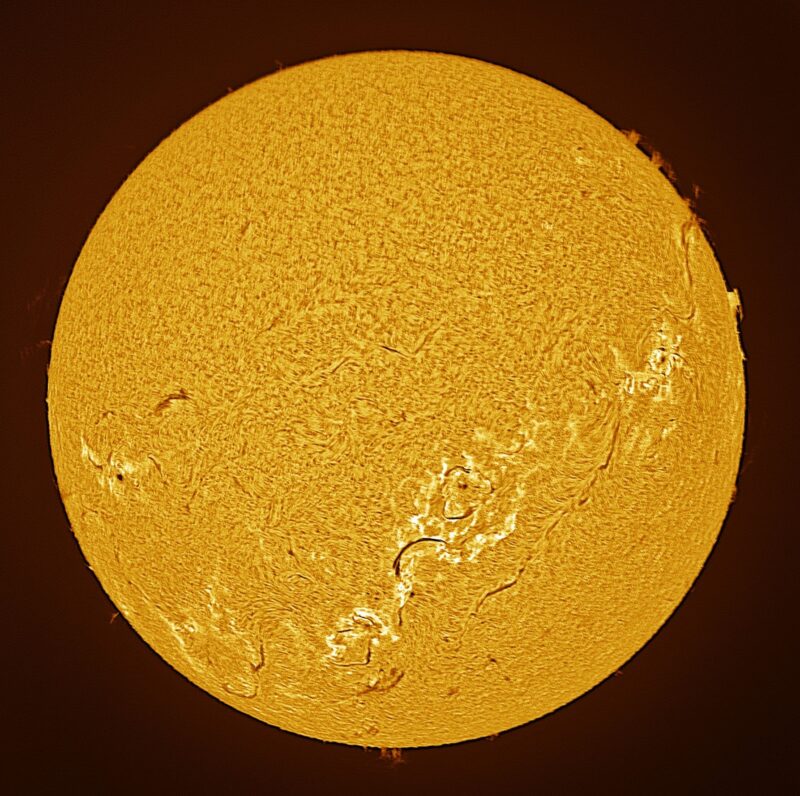 The sun, seen as a large yellow sphere with a mottled surface.