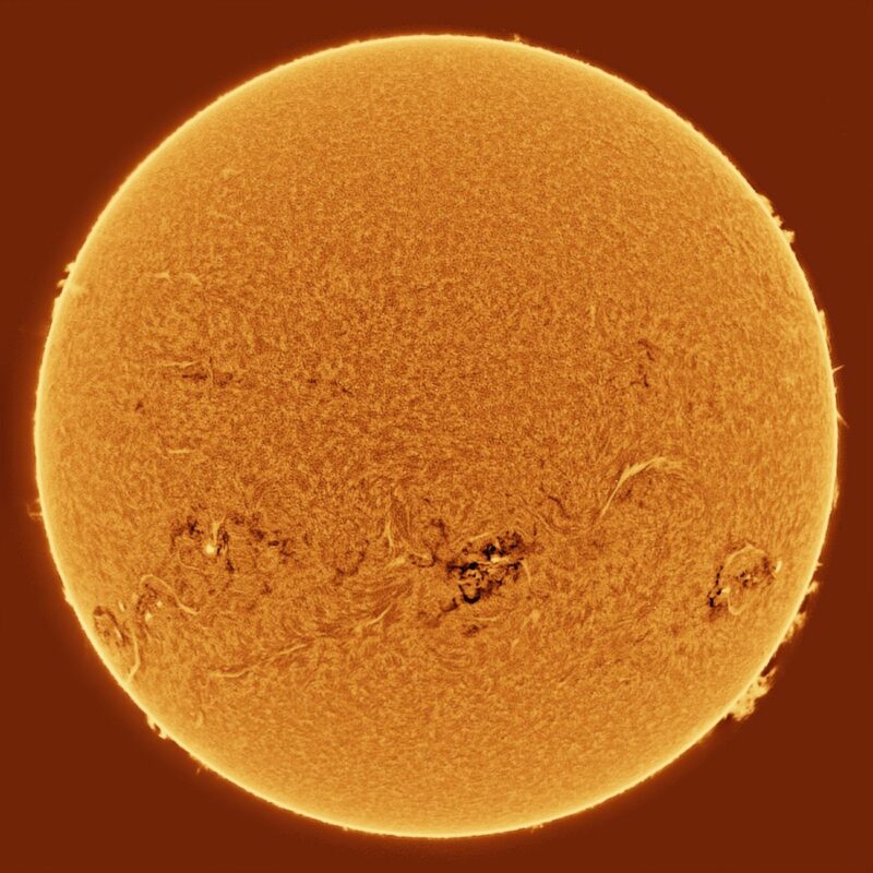 The sun, seen as a large yellow sphere with a mottled surface.