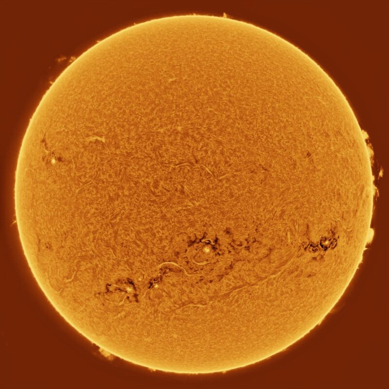 The sun, seen as a large yellow sphere with a mottled surface.