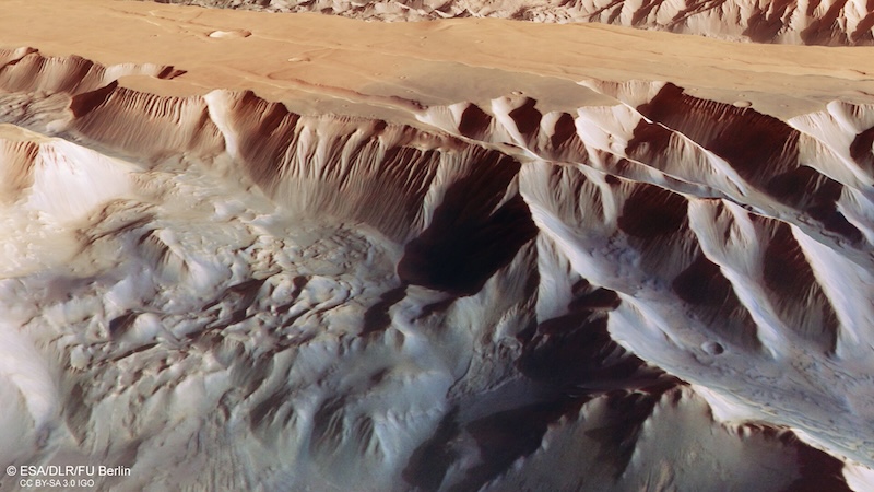 Exploring Mars' Grand Canyon: Aerial view of large canyon with steep walls and sharp-edged ridges.