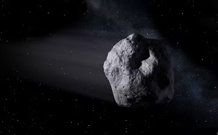 Asteroids: An irregular, gray rocky body - an asteroid - flying through the darkness of space.