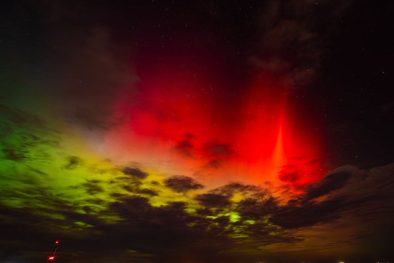 Red spikes and green glows from aurora.