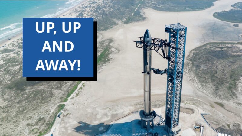 Starship: Tall spacecraft at gantry made of girders. White sand and ocean in background.