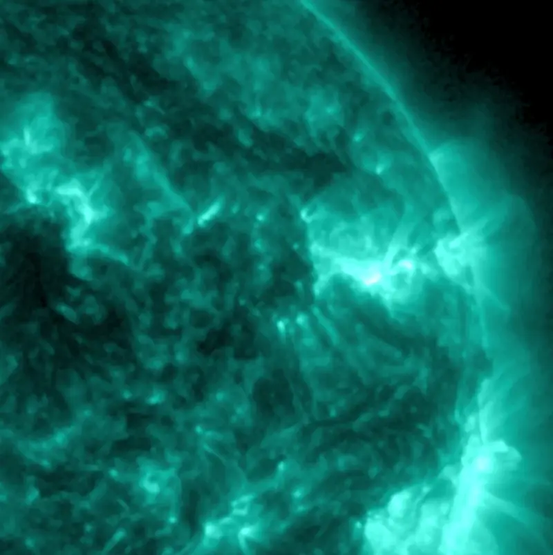 A quarter of the sun, mottled and sparkling with small explosions.