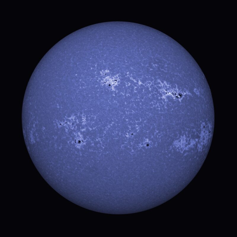 The sun, seen as a large blue sphere with a mottled surface.