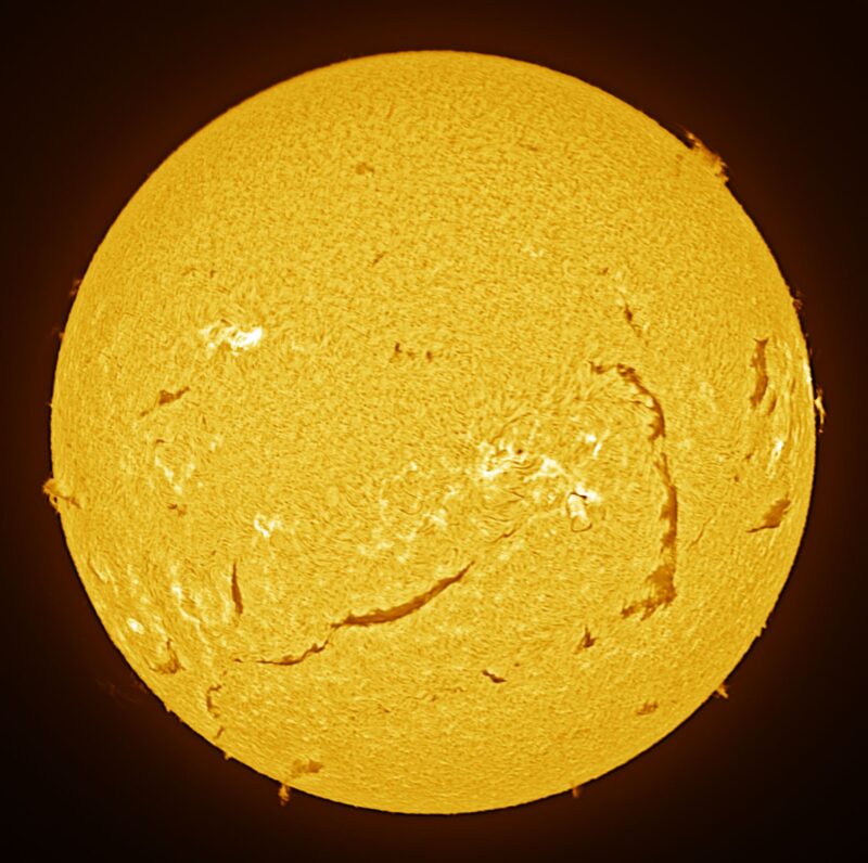 The sun, seen as a large yellow sphere with a mottled surface.