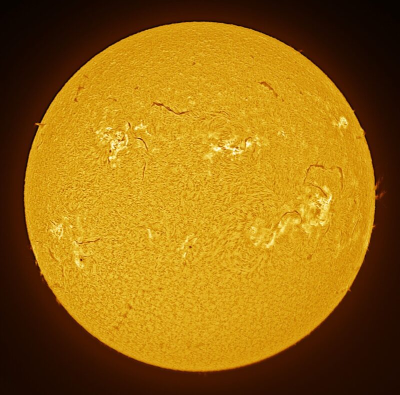 The sun, seen as a large yellow sphere with a mottled surface.