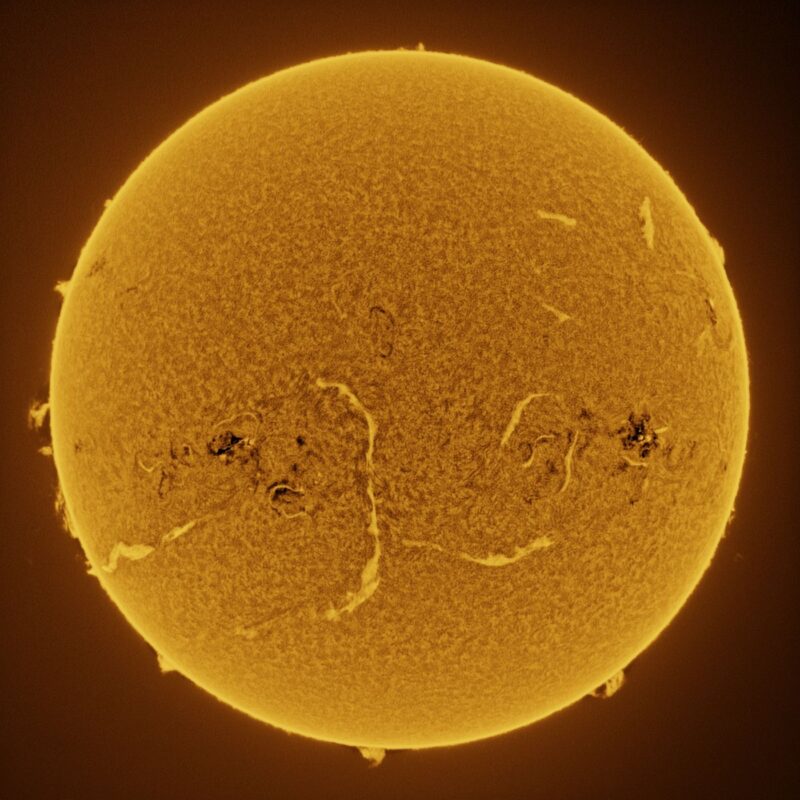 The sun, seen as a large yellow sphere with a mottled surface.