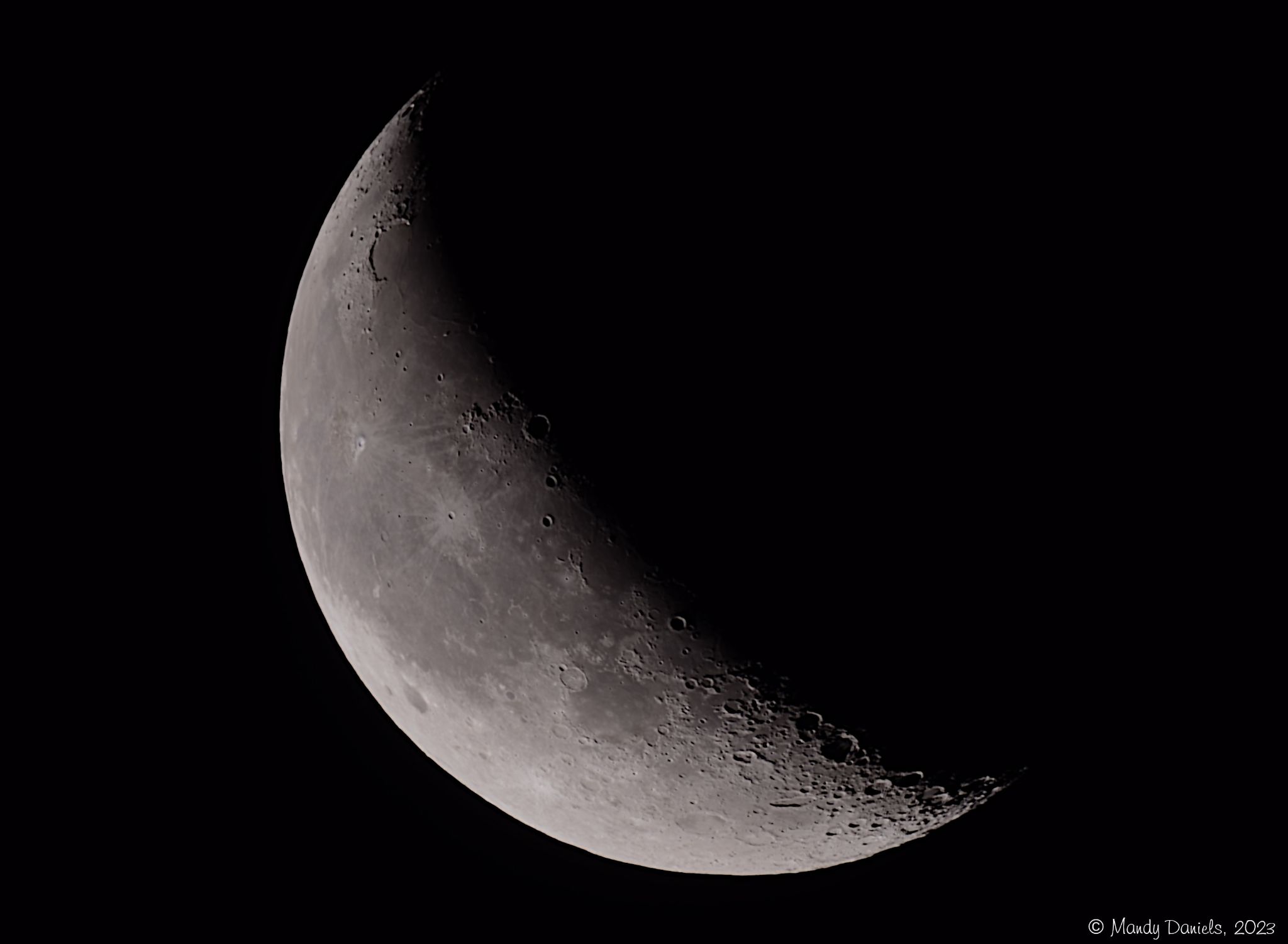Waning crescent moon against a dark sky, about 33% illuminated.