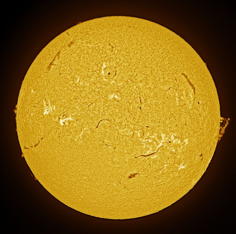 The sun, seen as a large yellow sphere with a mottled surface.
