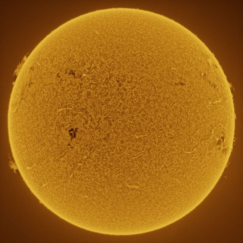 The sun, seen as a large yellow sphere with a mottled surface.