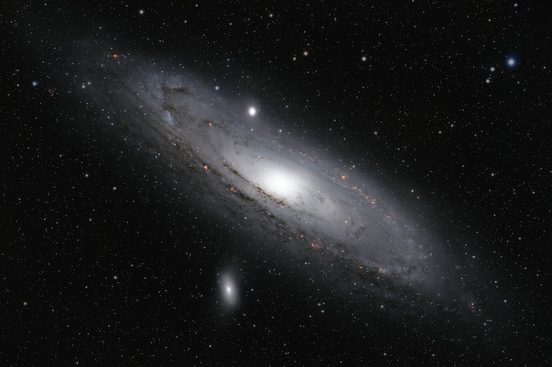 Andromeda galaxy: Large spiral formation of stars, gas and dust in space, angled from upper left to lower right. Many other stars are in the background.