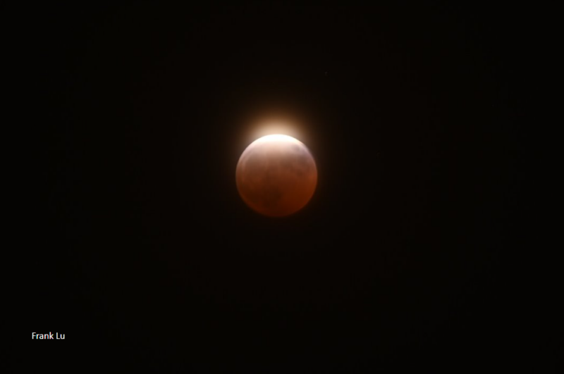 Orange moon with a bright halo on top.