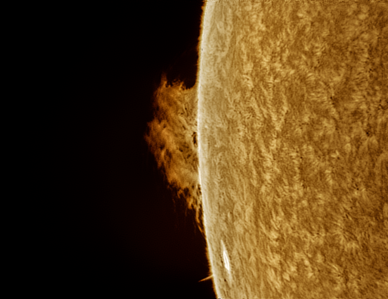 A sun close-up, seen as a sectional yellow sphere with a mottled surface.