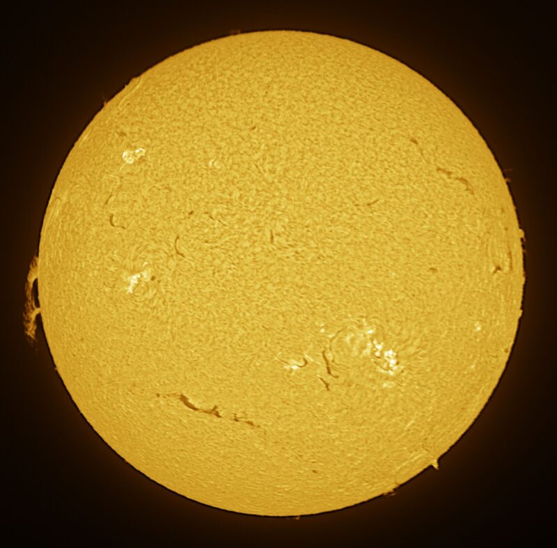 The sun, seen as a large yellow sphere with a mottled surface.