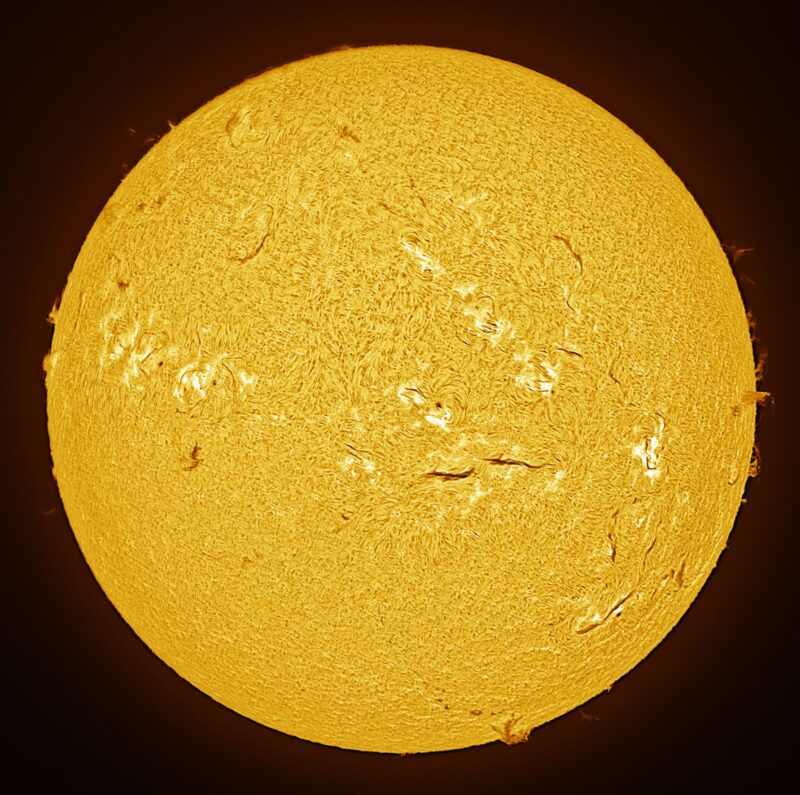 The sun, seen as a large yellow sphere with a mottled surface.