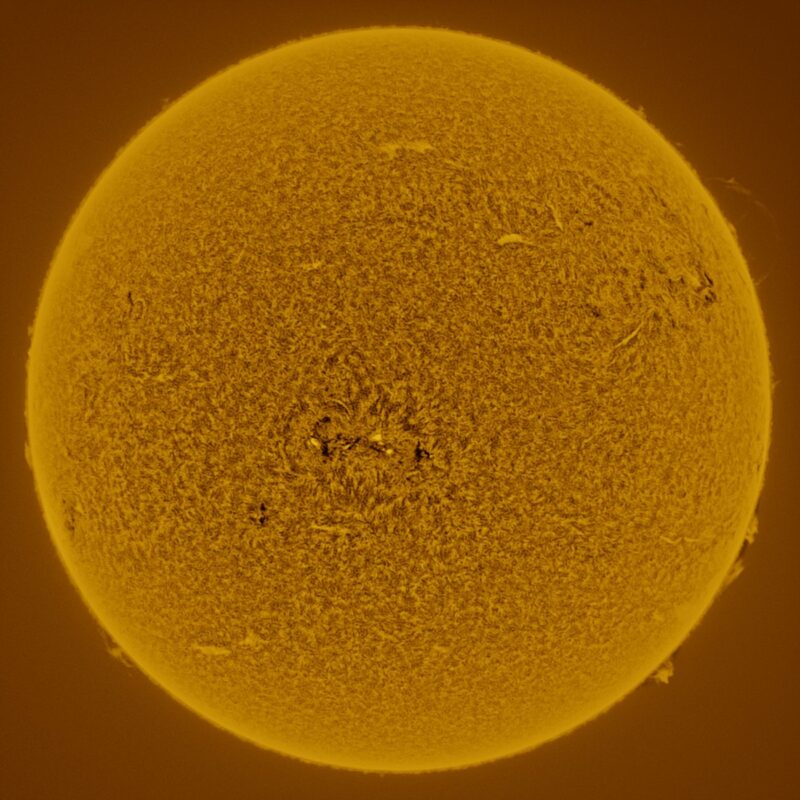 The sun, seen as a large yellow sphere with a mottled surface.