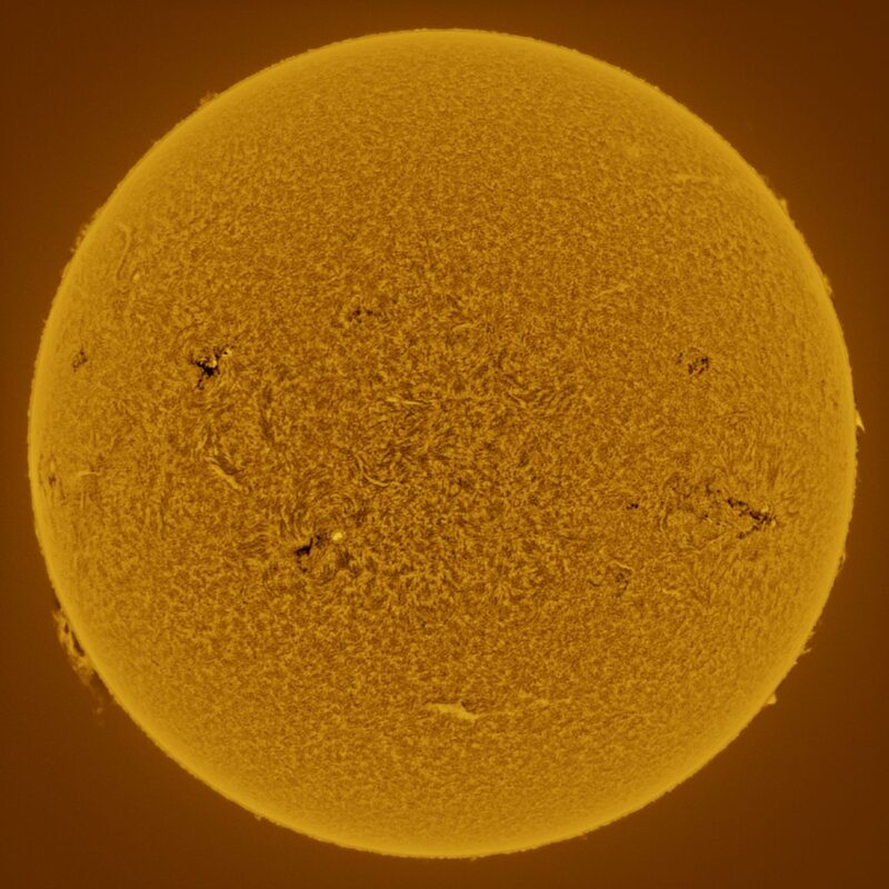 The sun, seen as a large yellow sphere with a mottled surface.