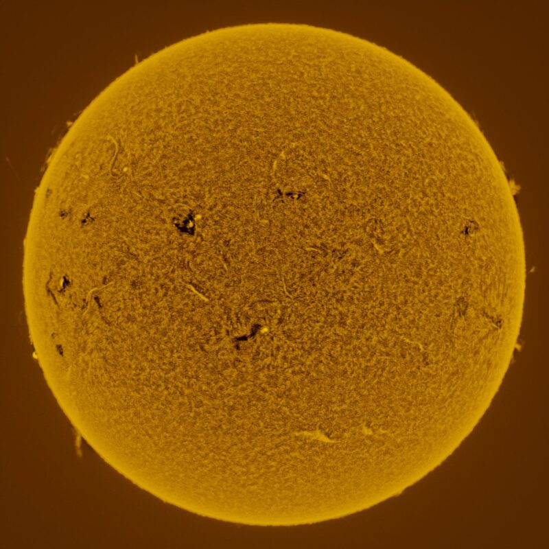 The sun, seen as a large yellow sphere with a mottled surface.