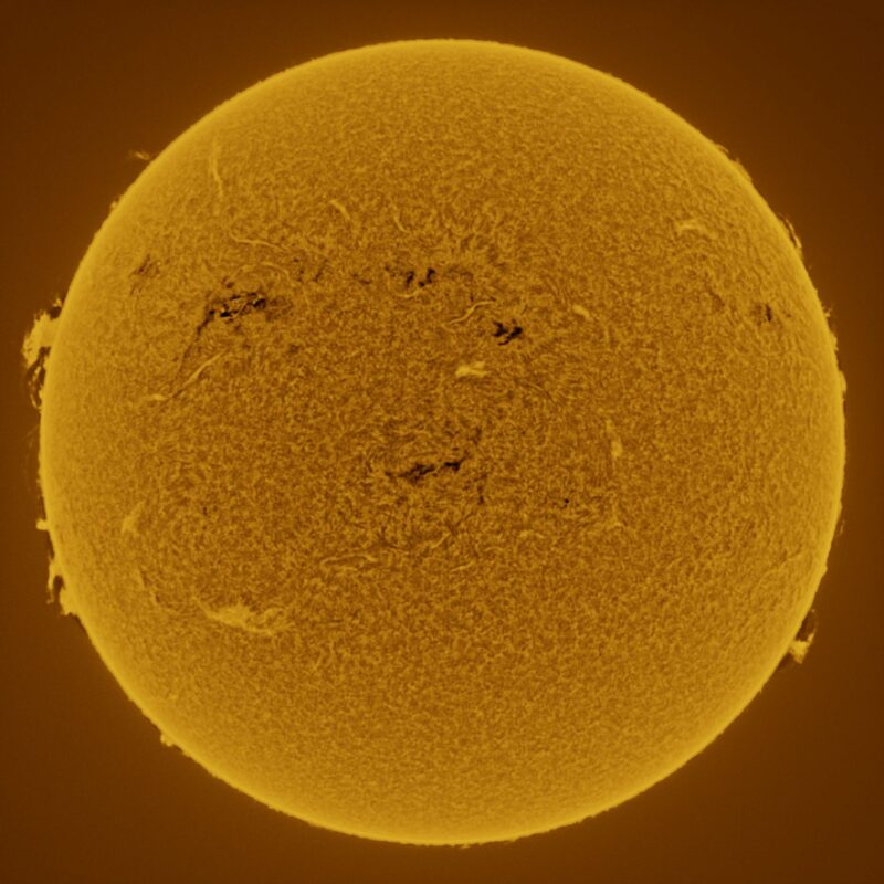 The sun, seen as a large yellow sphere with a mottled surface.