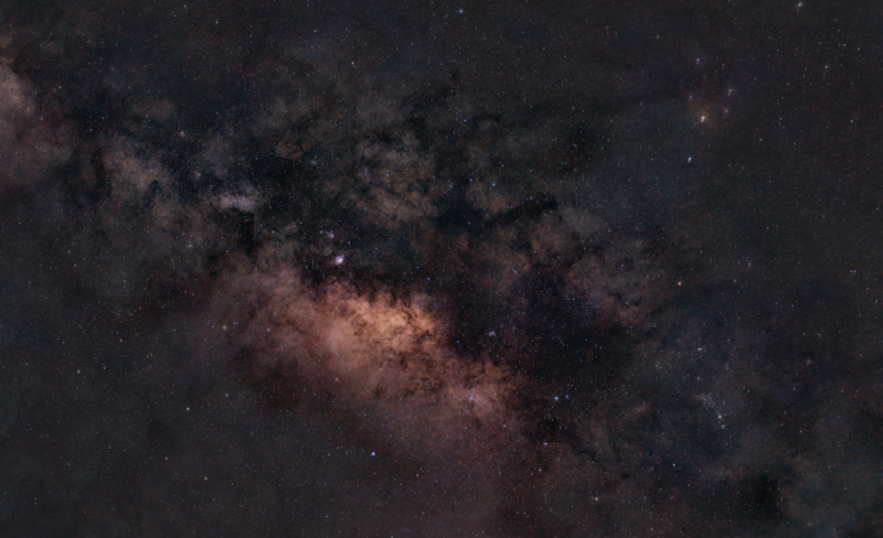 A starry band with some of the light hidden by dark dust and gas clouds.