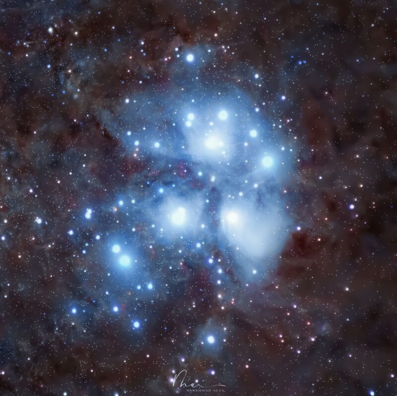 Large, complex clouds of blue gas scattered with dozens of bright stars, in a starfield.
