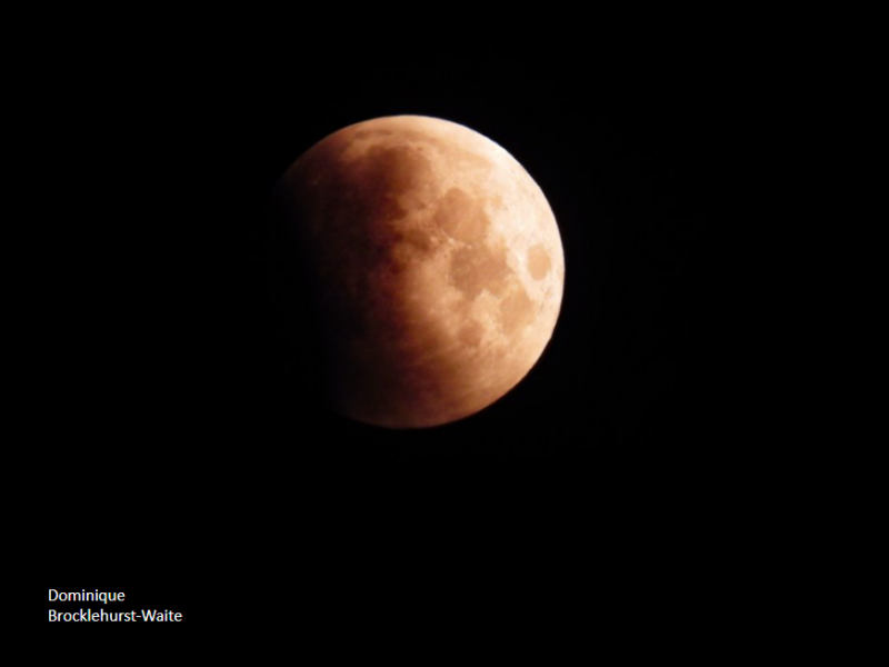 The left side of the moon is dark and not visible. The right side looks light orange.