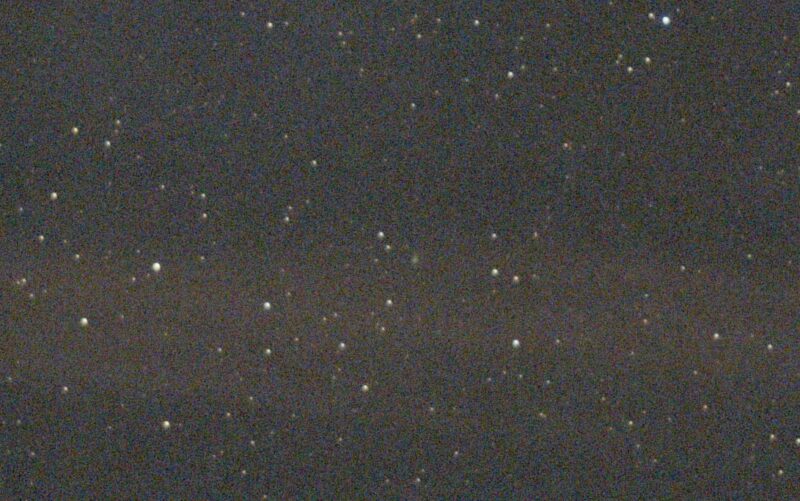 A starfield with a faint fuzz at the center.