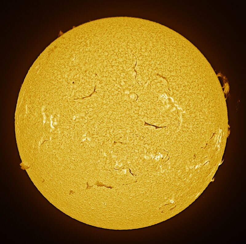The sun, seen as a large yellow sphere with a mottled surface.