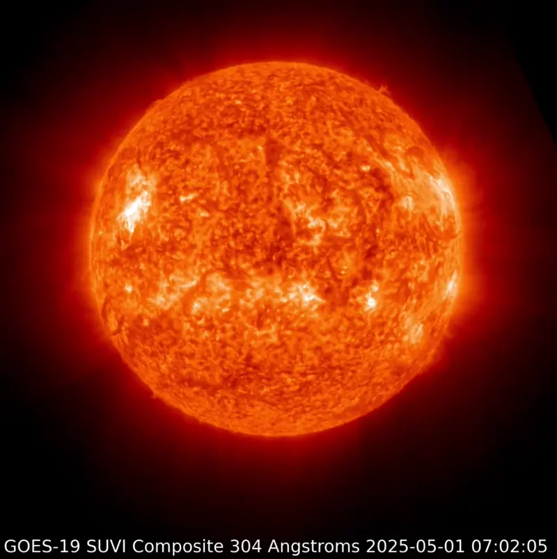 Surface of the sun with an irregular bright flash toward one side.
