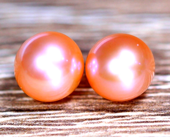 Two round, soft, shiny spheres that have a pinkish color.