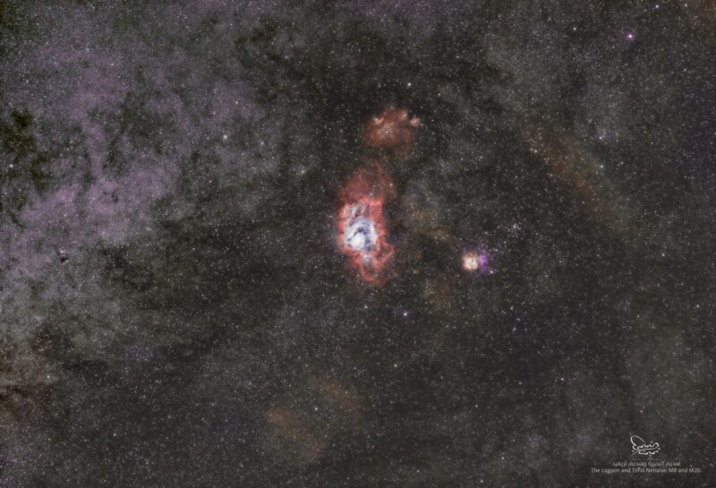 Two nebulous areas with red and blue highlights over a multitude of faint, distant stars.