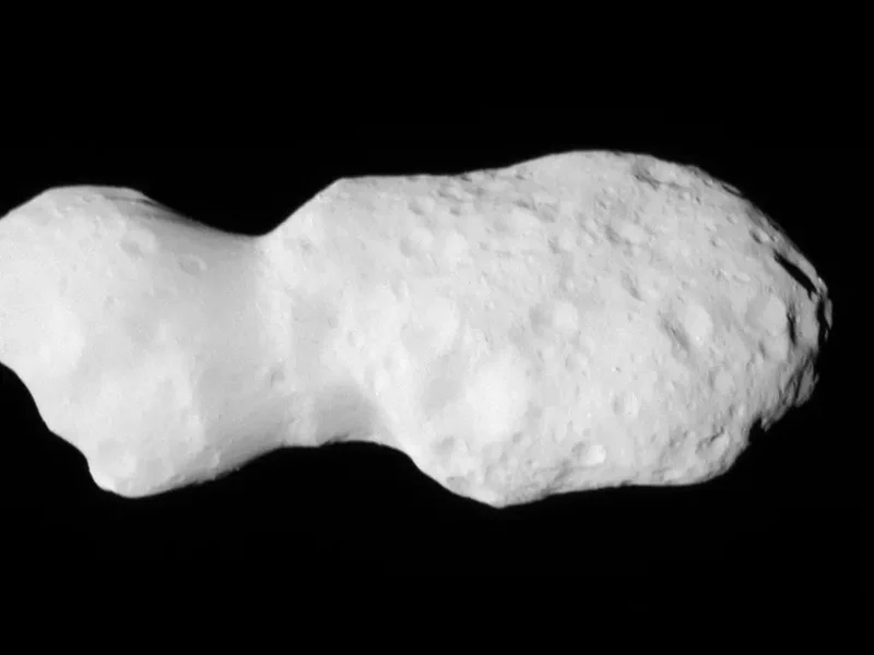 Closeup image of a potato shaped rock, covered with craters.