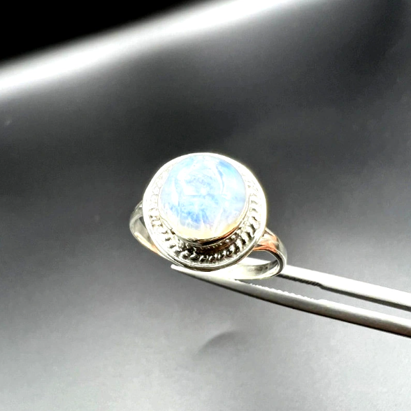 Light blue gem in a ring.