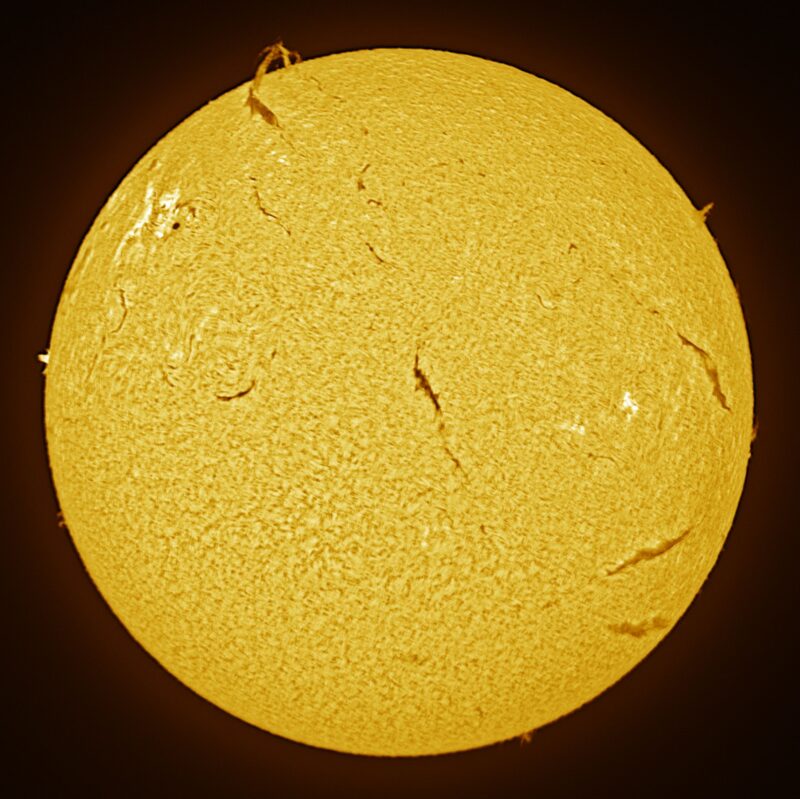 The sun, seen as a large yellow sphere with a mottled surface.