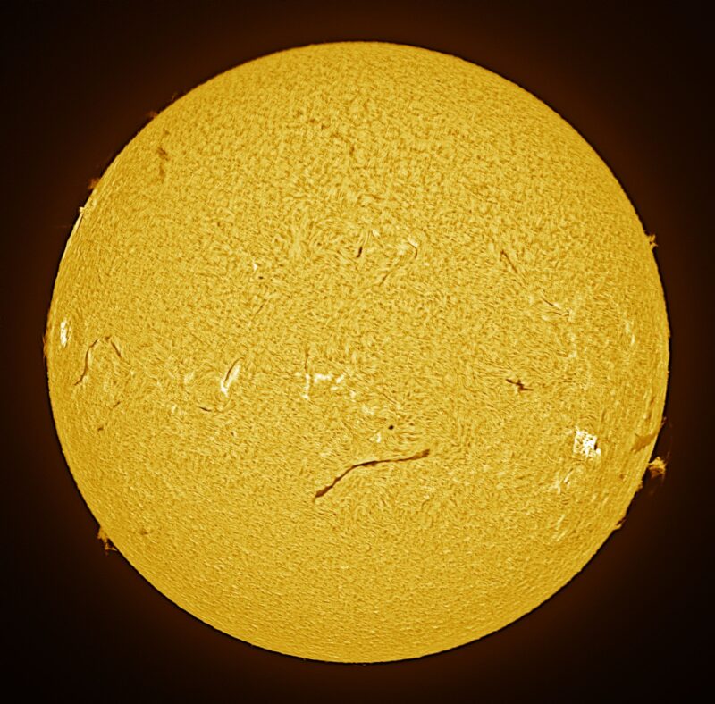 The sun, seen as a large yellow sphere with a mottled surface.