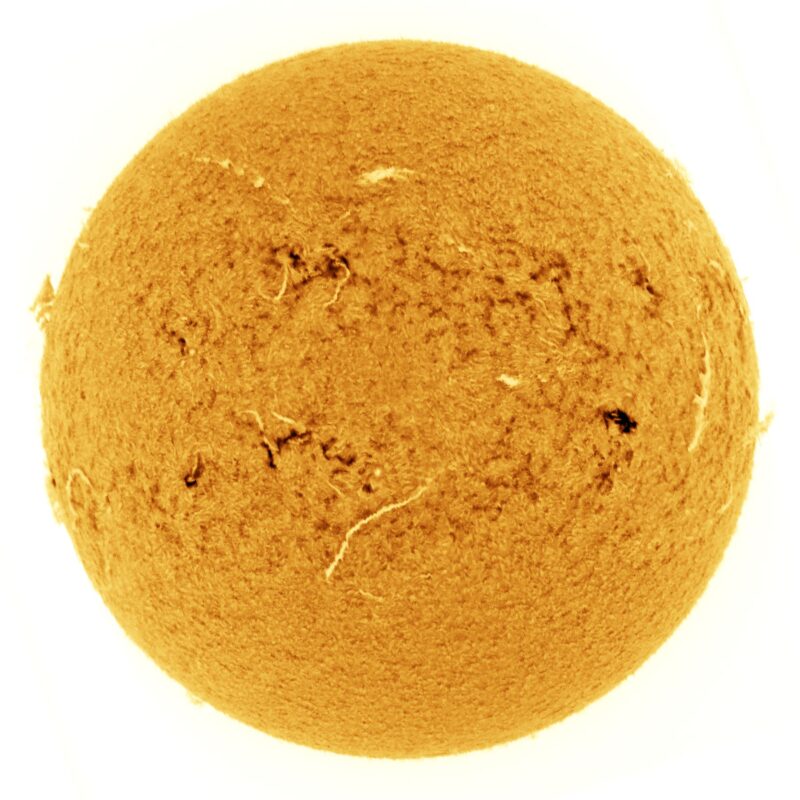 The sun, seen as a large yellow sphere with a mottled surface.