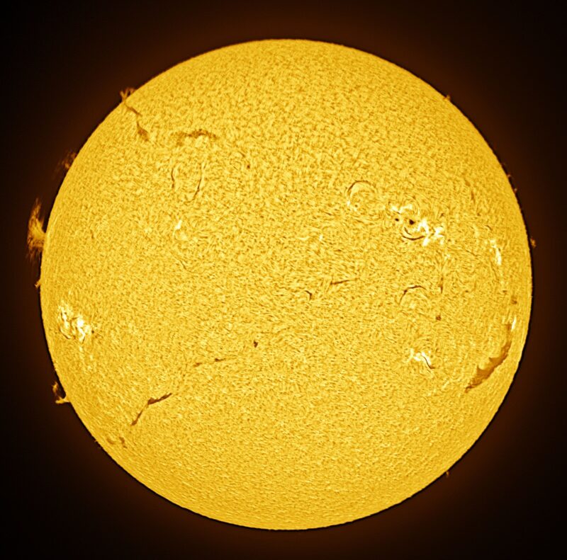 The sun, seen as a large yellow sphere with a mottled surface.