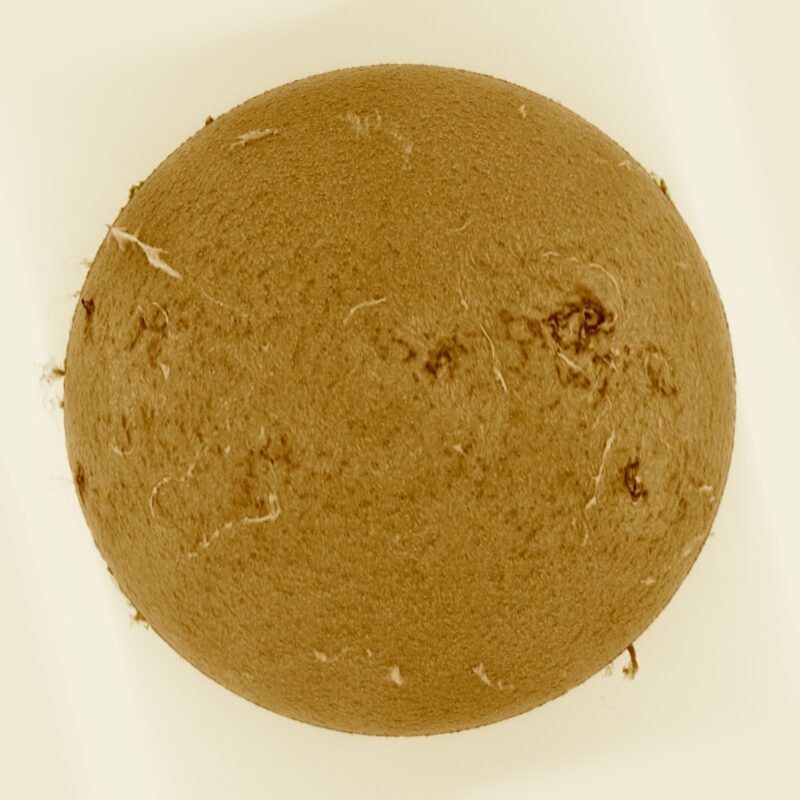 The sun, seen as a large yellow sphere with a mottled surface.