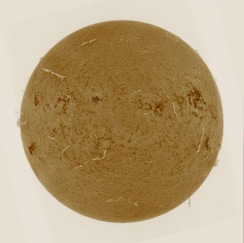 The sun, seen as a large yellow sphere with a mottled surface.