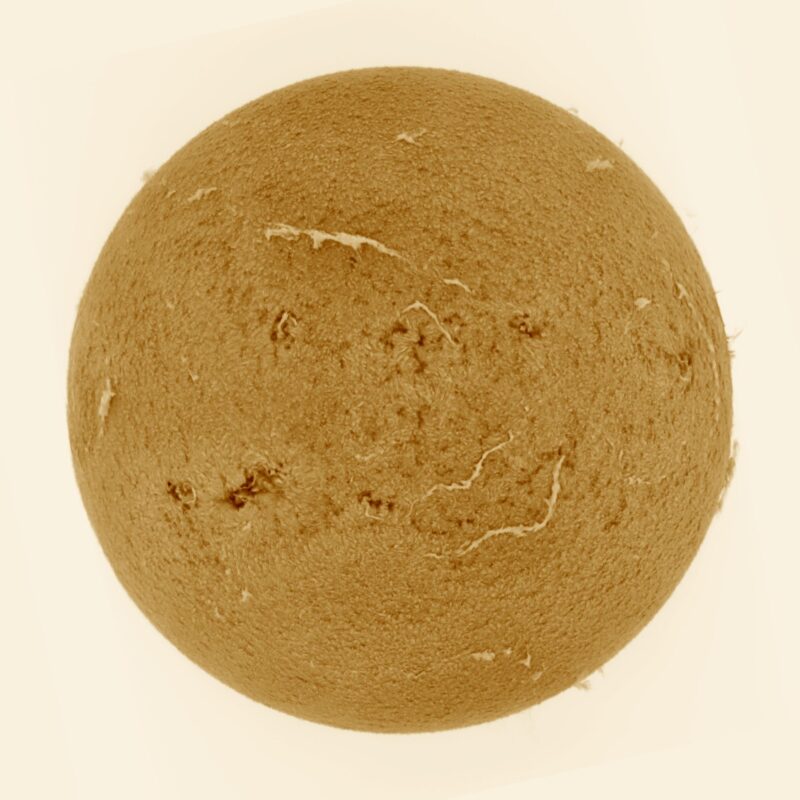 The sun, seen as a large yellow sphere with a mottled surface.