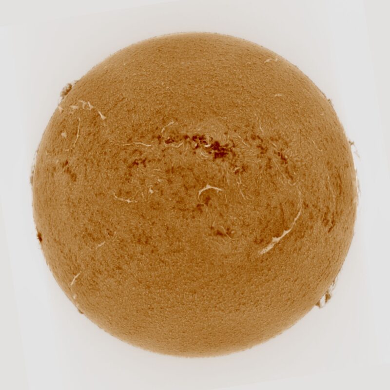 The sun, seen as a large yellow sphere with a mottled surface.
