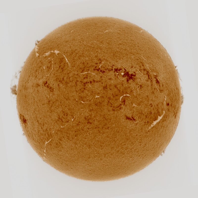 The sun, seen as a large yellow sphere with a mottled surface.