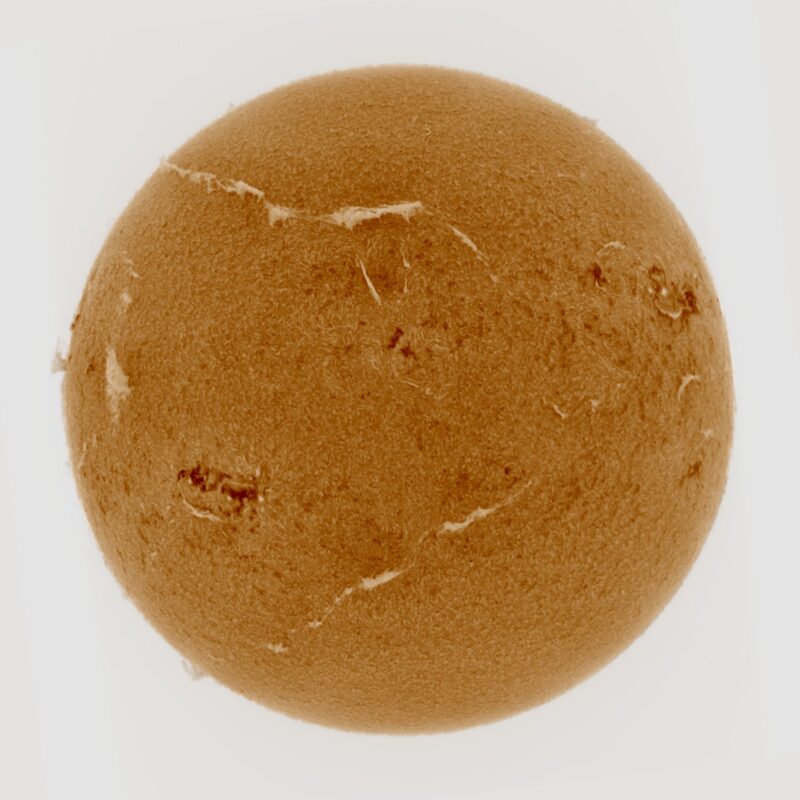 The sun, seen as a large yellow sphere with a mottled surface.