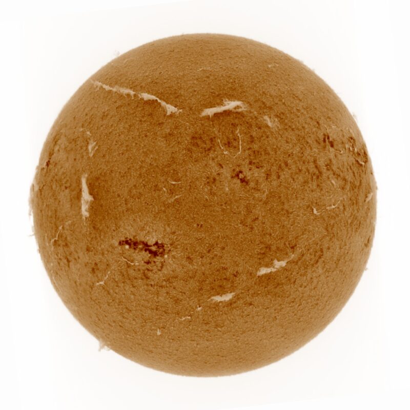 The sun, seen as a large yellow sphere with a mottled surface.