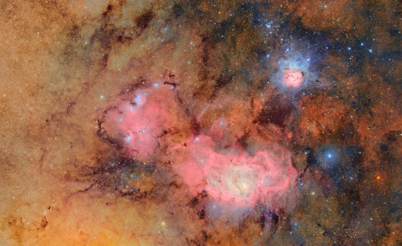 Jam-packed starfield with some dark gas and reddish areas plus a smaller blue and pink areas.