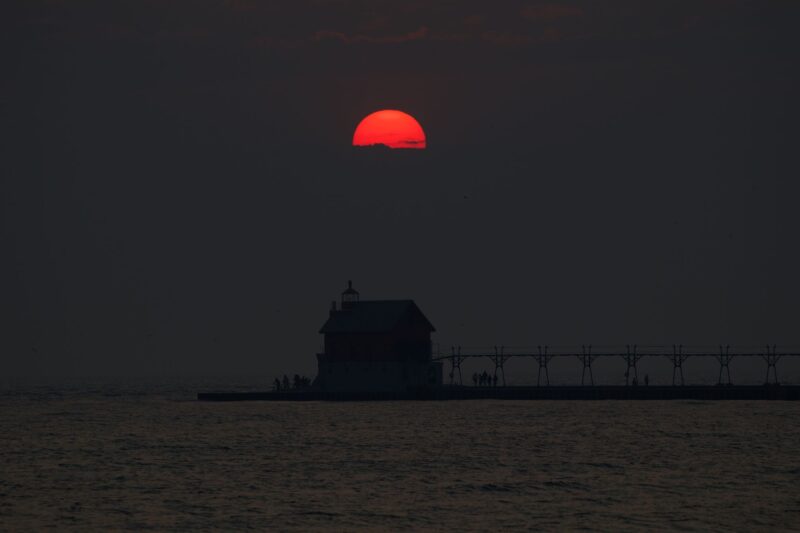 Dark scenery with half a red sun.