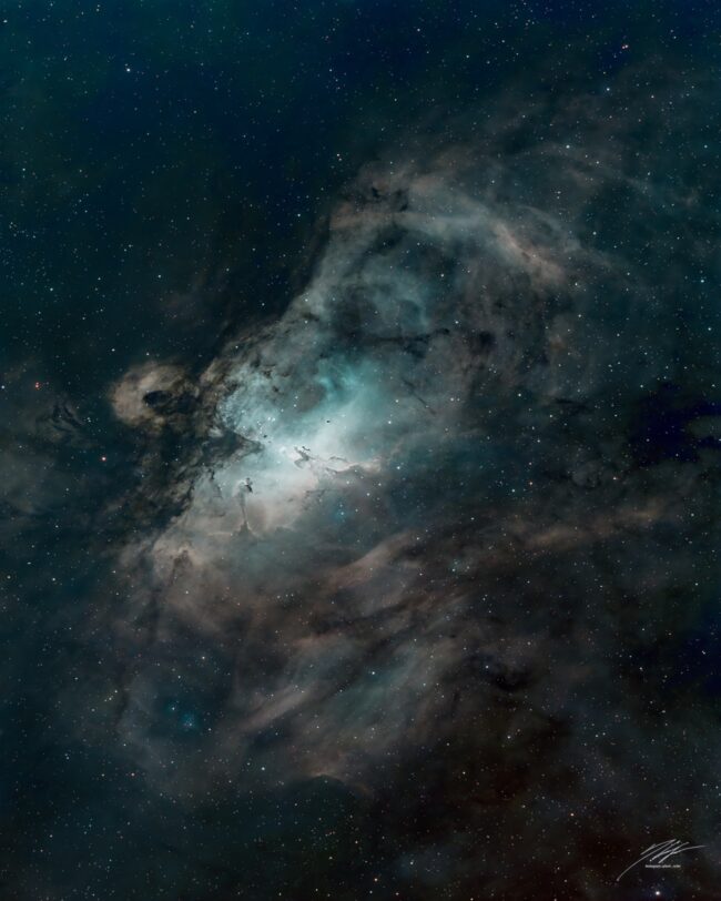 Large, expansive swirl of greenish nebulosity with numerous background stars.